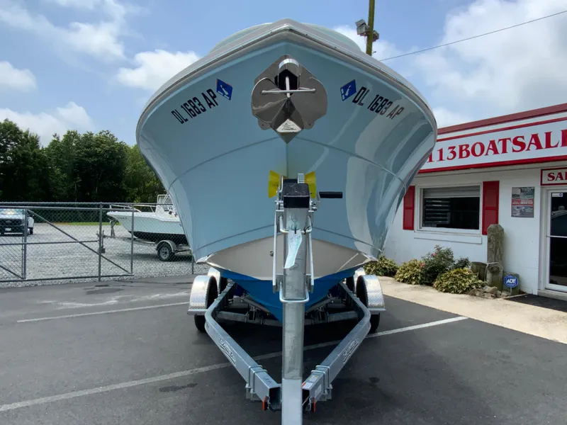 Slide: The Image of 2023 Cobia 240 Center Console boat on trailer at dealership. - 4