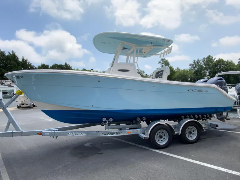 Slide: The Image of 2023 Cobia 240 Center Console boat on trailer under cloudy sky. - 6