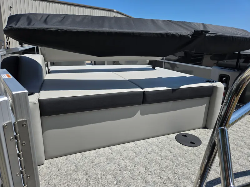 Slide: The Image of 2025 Trifecta 24 UL LET2.75 pontoon boat with cushioned seating and canopy. - 5