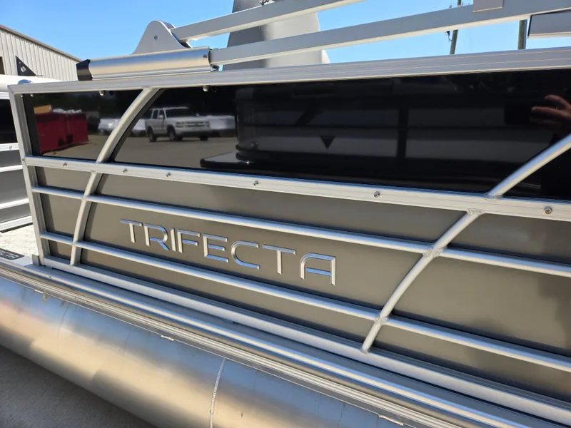 Slide: The Image of 2025 Trifecta 24 UL LET2.75 pontoon boat with sleek metallic design. - 7