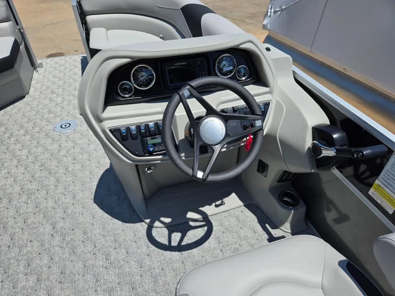 Slide: The Image of 2025 Trifecta 24 UL LET2.75 boat dashboard with steering wheel and control panel. - 8