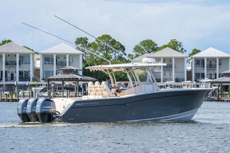 Slide: The Image of 2017 Grady-White 336 Canyon boat cruising near waterfront homes. - 15