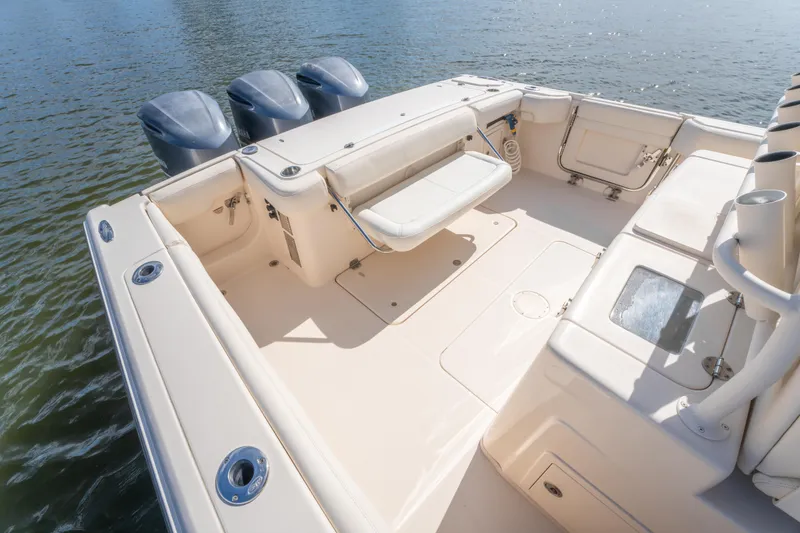 Slide: The Image of 2017 Grady-White 336 Canyon boat deck with triple outboard engines on water. - 18