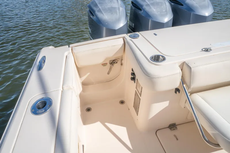 Slide: The Image of 2017 Grady-White 336 Canyon boat interior with Yamaha engines, featuring seating and cup holders. - 21
