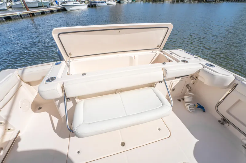 Slide: The Image of 2017 Grady-White 336 Canyon boat interior with open storage compartment by the water. - 22