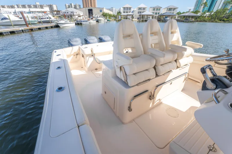 Slide: The Image of 2017 Grady-White 336 Canyon boat interior with plush seating at marina. - 23