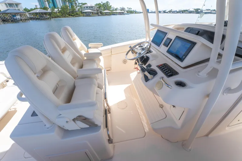 Slide: The Image of 2017 Grady-White 336 Canyon boat interior with helm and seating. - 24