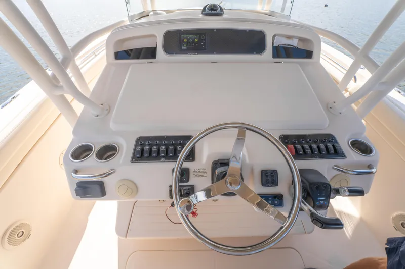 Slide: The Image of 2017 Grady-White 336 Canyon boat helm with steering wheel and control panel. - 28