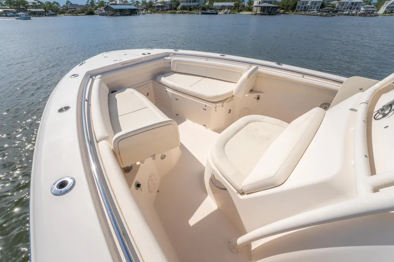 Slide: The Image of 2017 Grady-White 336 Canyon boat interior with cushioned seating on calm water. - 29
