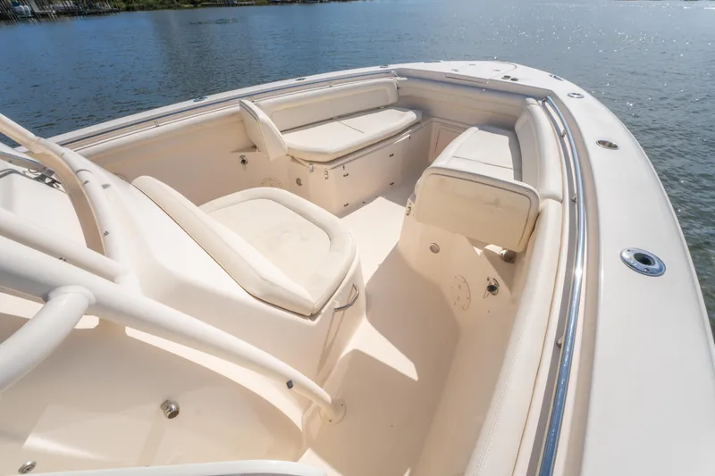 Slide: The Image of 2017 Grady-White 336 Canyon boat interior with seating, on calm water. - 31