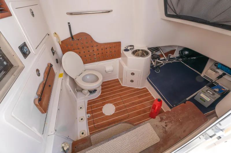 Slide: The Image of 2017 Grady-White 336 Canyon boat interior with toilet and sink. - 33