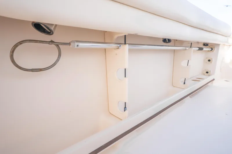 Slide: The Image of 2017 Grady-White 336 Canyon boat interior detail, showcasing rod holders and storage features. - 34