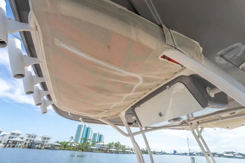 Slide: The Image of 2017 Grady-White 336 Canyon boat interior with rod holders and storage compartment. - 35