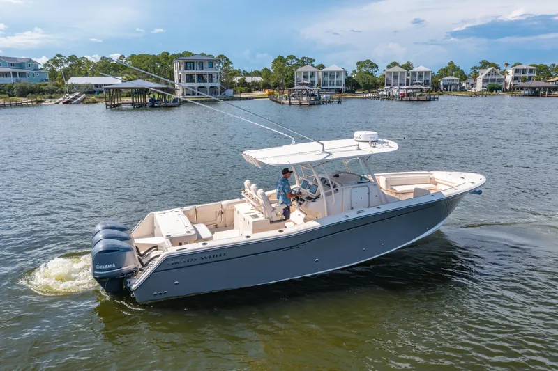 Slide: The Image of 2017 Grady-White 336 Canyon boat cruising on a scenic waterfront. - 37