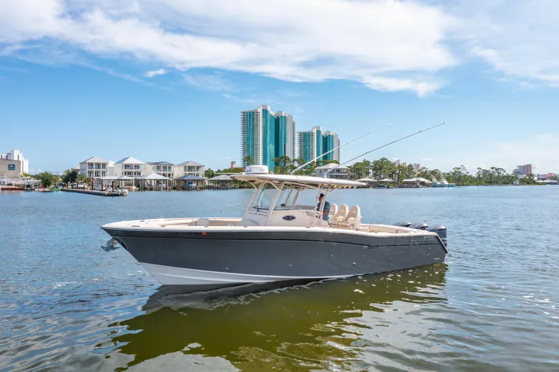 Slide: The Image of 2017 Grady-White 336 Canyon boat on water with cityscape background. - 4