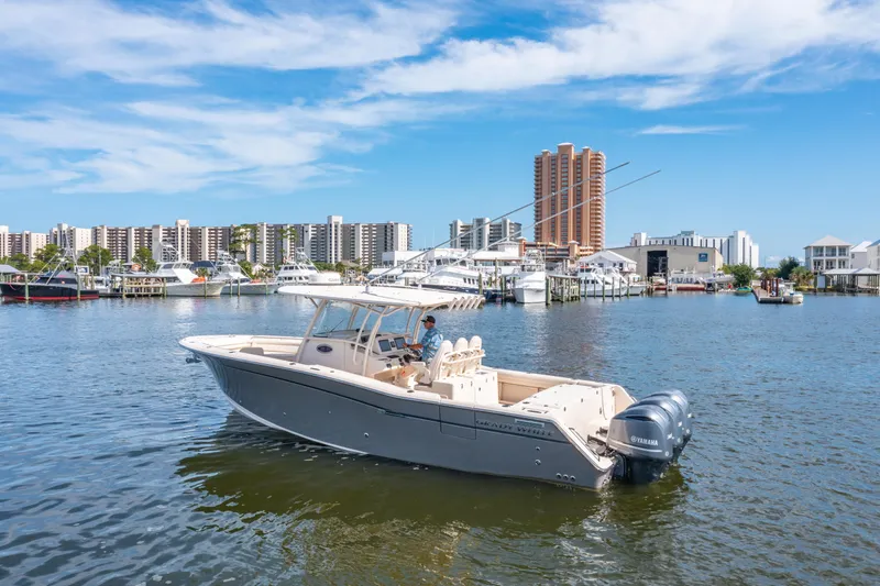Slide: The Image of 2017 Grady-White 336 Canyon boat on water, city skyline in background. - 5