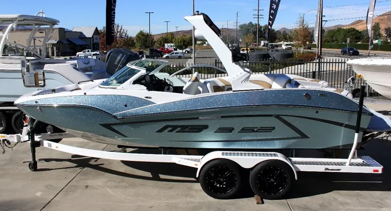 The Image of 2021 MB B23 Alpha boat on trailer, metallic finish, parked outdoors. - 1