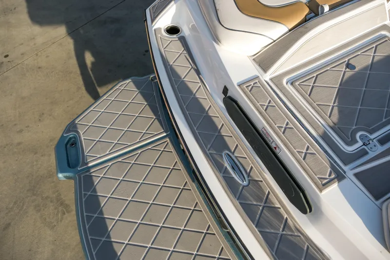 Slide: The Image of 2021 MB B23 Alpha boat deck with cushioned seating and textured flooring. - 18