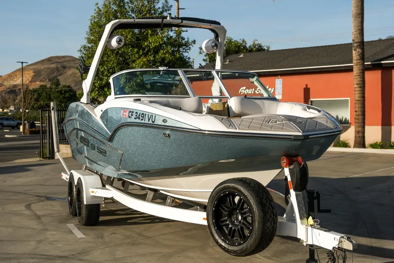 Slide: The Image of 2021 MB B23 Alpha boat on trailer in sunny outdoor setting. - 8