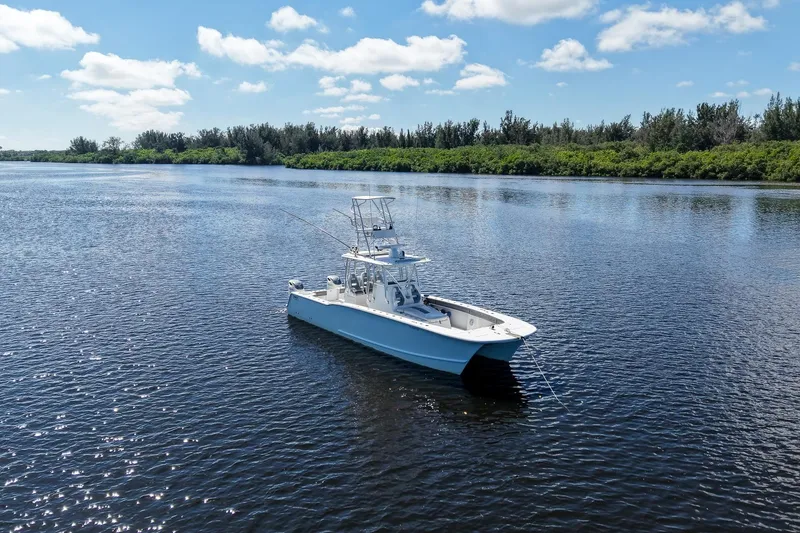 Slide: The Image of 2020 Tideline 365 Offshore boat on calm water under a clear blue sky. - 4