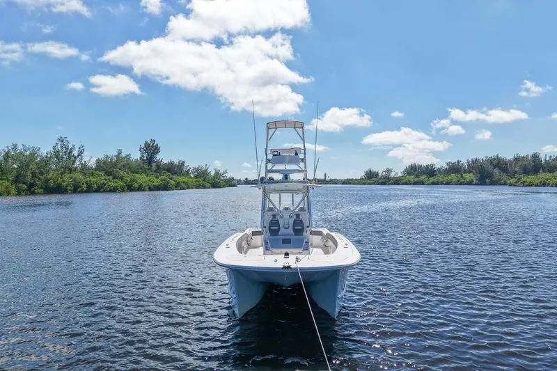 Slide: The Image of 2020 Tideline 365 Offshore boat on a serene river under a clear blue sky. - 7