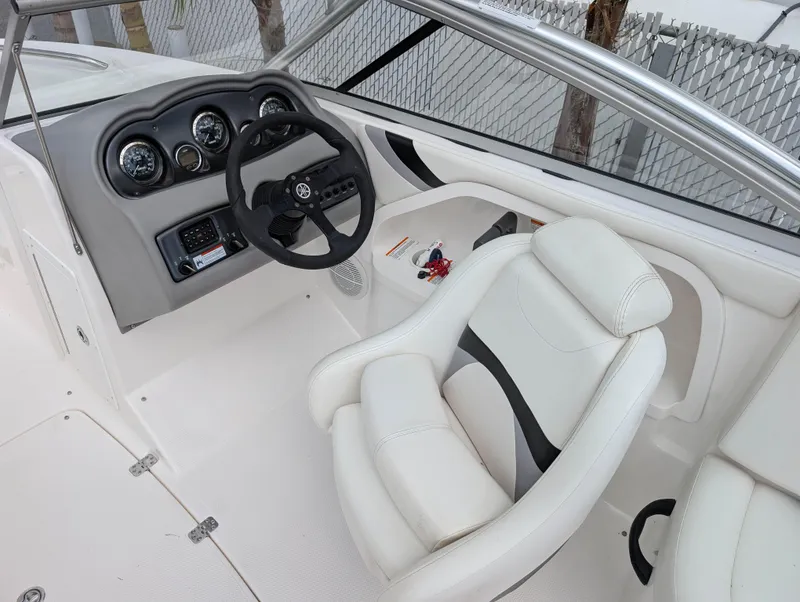 Slide: The Image of 2004 Yamaha Boats AR230 HO cockpit with steering wheel and white seating. - 10