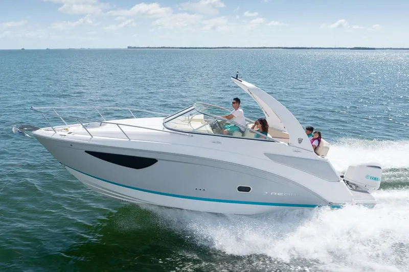 The Image of 2026 Regal 26 XO boat in showroom, sleek design with black canopy. - 0