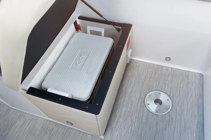 Slide: The Image of 2026 Regal 26 XO boat storage compartment with cup holders and hydraulic lift. - 11
