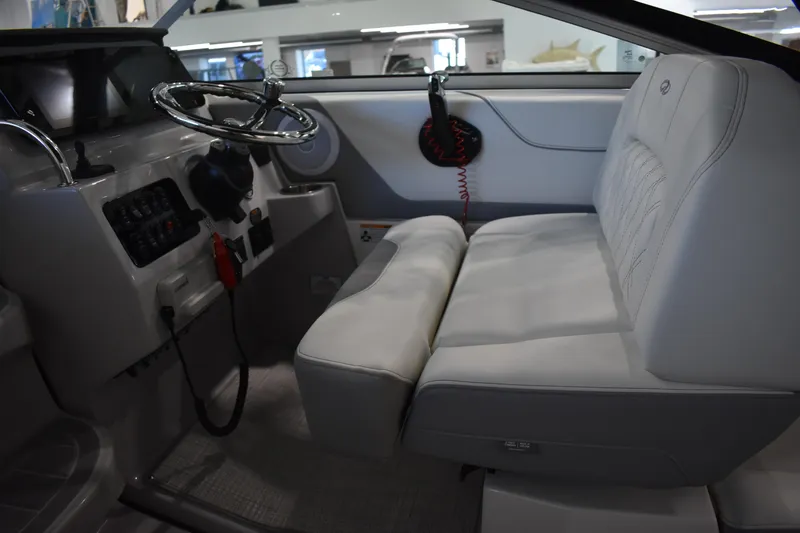 Slide: The Image of Interior of 2026 Regal 26 XO boat with steering wheel and cushioned seating. - 23