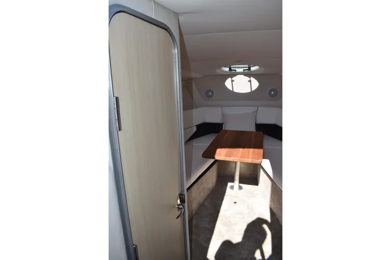 Slide: The Image of 2026 Regal 26 XO cabin interior with table and seating, modern design. - 26