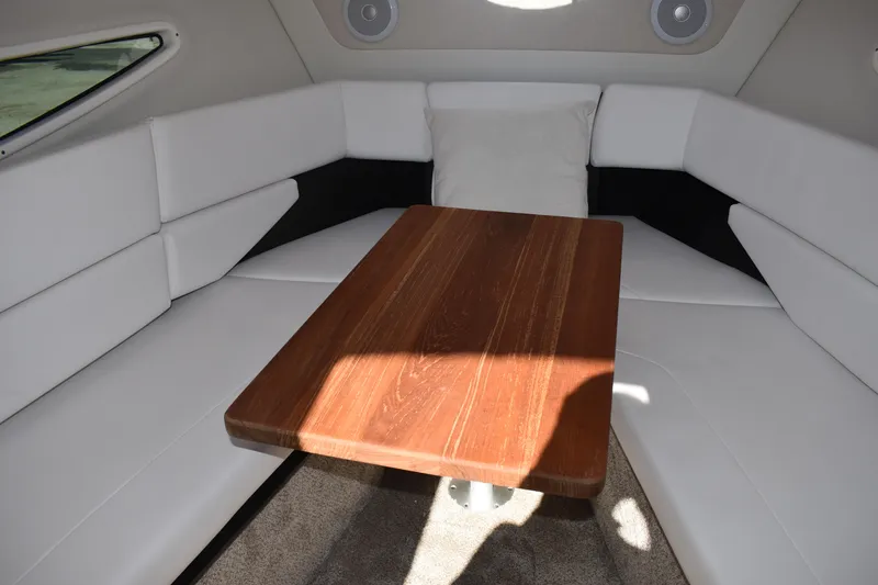 Slide: The Image of Interior of 2026 Regal 26 XO boat with wooden table and white seating. - 27