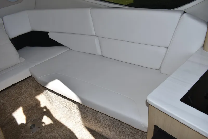 Slide: The Image of Interior of 2026 Regal 26 XO boat with white seating and carpeted floor. - 30