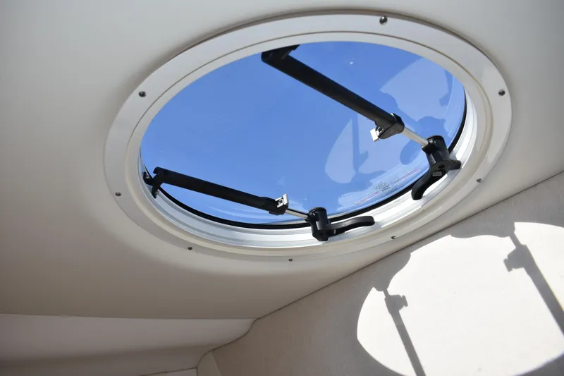 Slide: The Image of Round window on 2026 Regal 26 XO boat, showcasing blue sky view. - 31