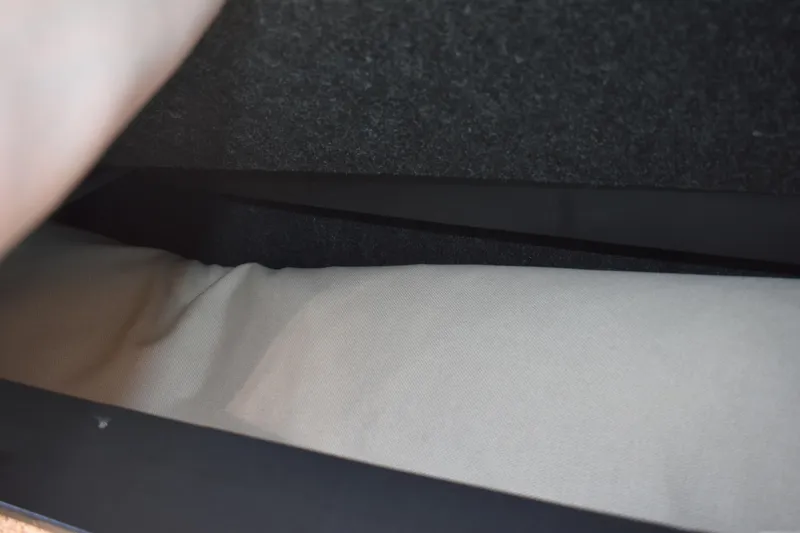 Slide: The Image of Interior storage compartment of 2026 Regal 26 XO boat, featuring fabric lining. - 33