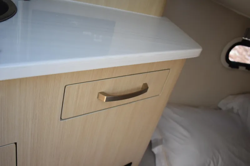 Slide: The Image of 2026 Regal 26 XO interior with wooden cabinet and sleek countertop. - 41