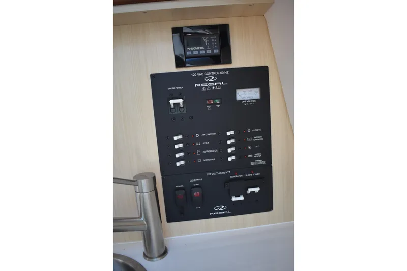 Slide: The Image of Control panel of 2026 Regal 26 XO boat, featuring various switches and indicators. - 43