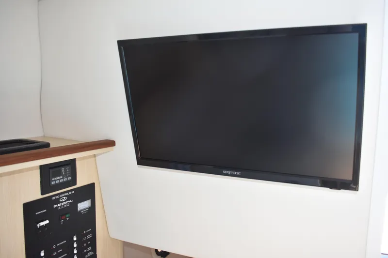 Slide: The Image of 2026 Regal 26 XO interior with wall-mounted TV and control panel. - 44