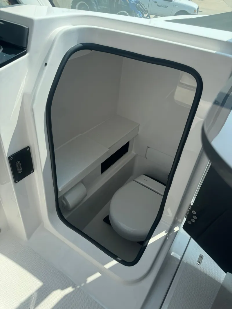 Slide: The Image of 2025 Blackfin 252 DC boat interior with compact marine toilet. - 17