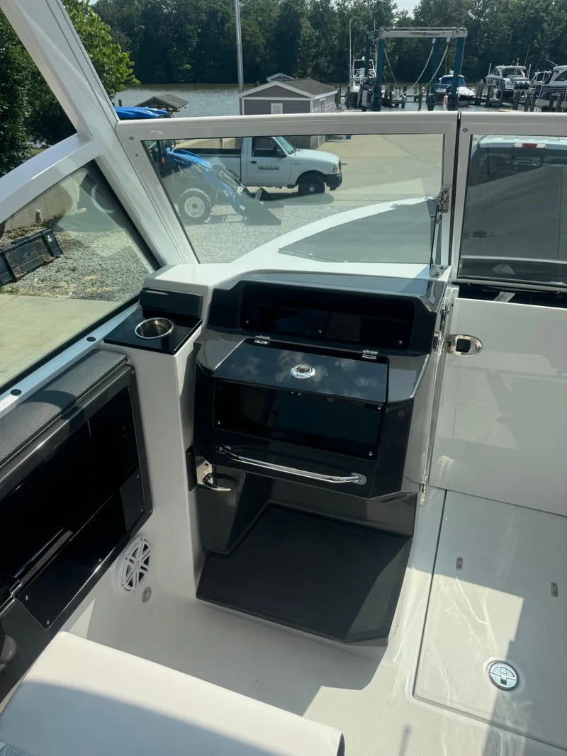 Slide: The Image of 2025 Blackfin 252 DC boat cockpit with modern controls and seating. - 25