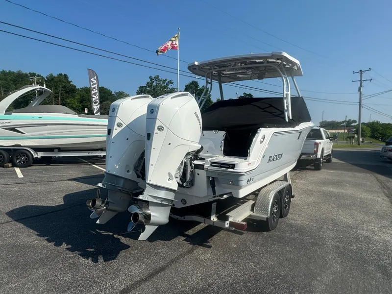 Slide: The Image of 2025 Blackfin 252 DC boat with dual outboard engines on a trailer. - 4