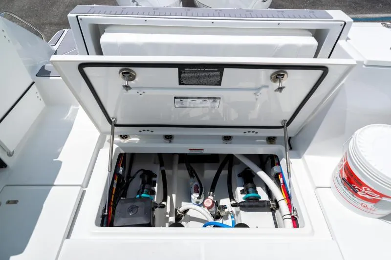 Slide: The Image of Open hatch of 2025 Blackfin 252 DC boat showing internal components and wiring. - 9