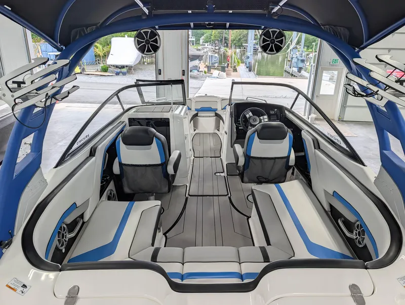 Slide: The Image of 2019 Yamaha Boats 242X E-Series interior with blue and gray seating, modern design. - 12