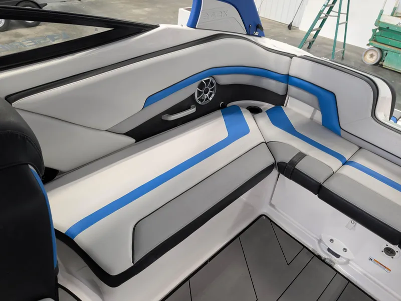 Slide: The Image of 2019 Yamaha Boats 242X E-Series interior with blue and gray seating, modern design. - 13