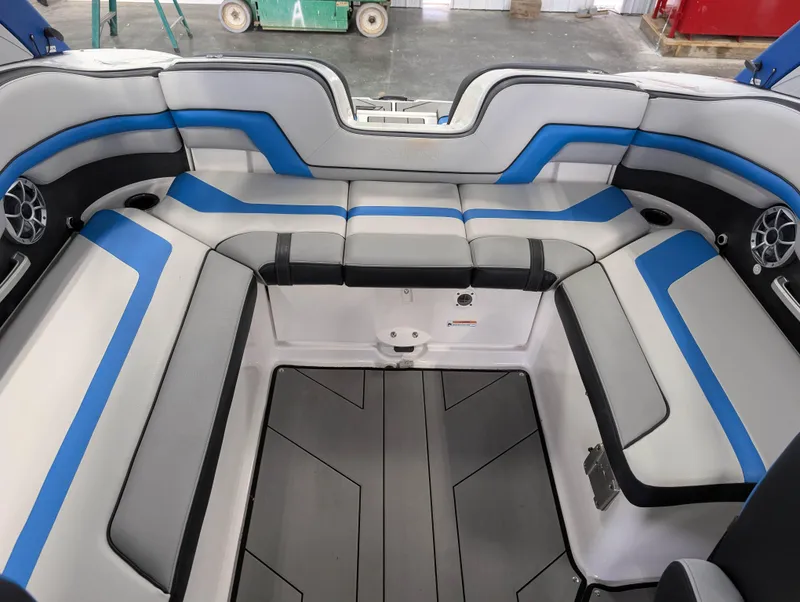 Slide: The Image of 2019 Yamaha Boats 242X E-Series interior with blue and gray seating. - 14