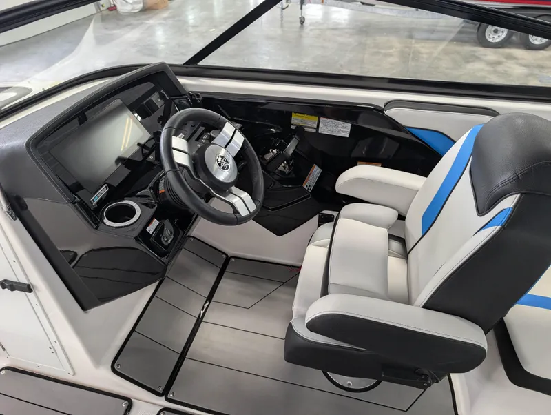 Slide: The Image of 2019 Yamaha Boats 242X E-Series cockpit with steering wheel and modern dashboard. - 17