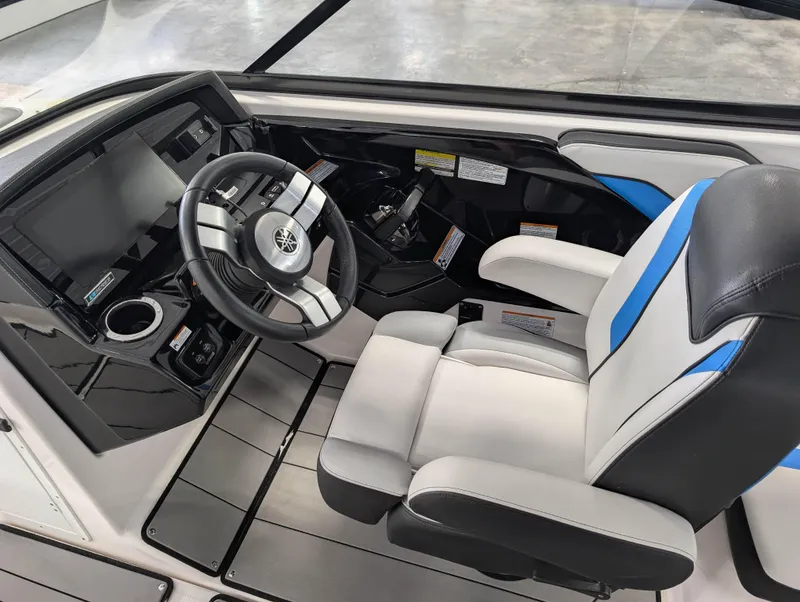 Slide: The Image of 2019 Yamaha Boats 242X E-Series cockpit with steering wheel and captain's chair. - 19