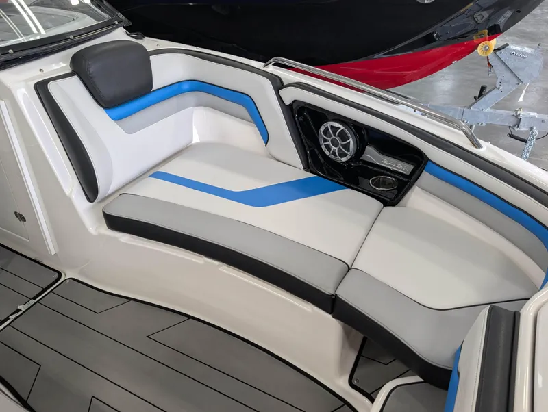 Slide: The Image of 2019 Yamaha Boats 242X E-Series interior with blue and gray seating and speaker system. - 25