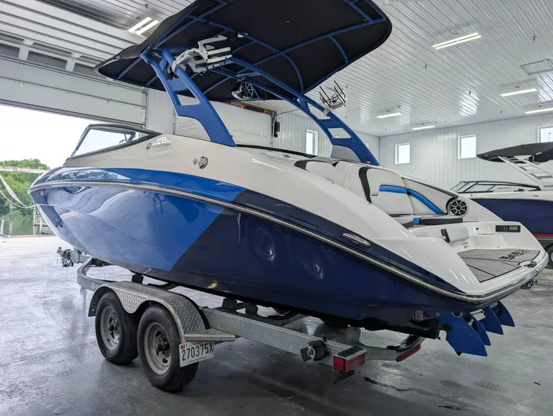 Slide: The Image of 2019 Yamaha Boats 242X E-Series on trailer in indoor storage facility. - 6