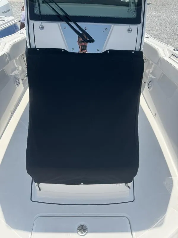 Slide: The Image of 2025 Blackfin 272 CC boat console with black cover, sleek design. - 11