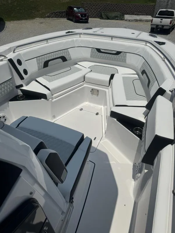 Slide: The Image of 2025 Blackfin 272 CC boat interior with cushioned seating and modern design. - 14